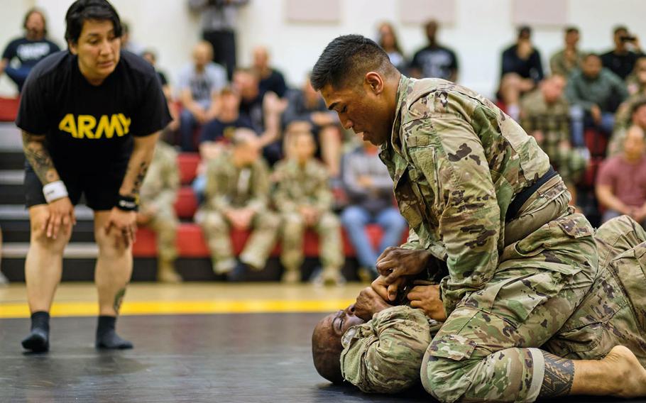 Pfc. Frazer Taua, top, and Sgt. Daquon Jeffress of the 2nd Infantry Division compete during the Friday Night Fights debut tournament at Camp Humphreys, South Korea, May 10, 2019.