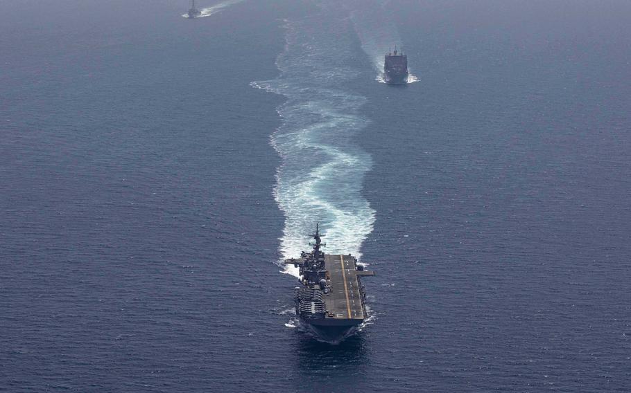 The amphibious assault ship USS Kearsarge , center, the dry cargo and ammunition ship USNS Alan Shepard, right, and the guided-missile destroyer USS McFaul transit the Strait of Hormuz, May 7, 2019. 