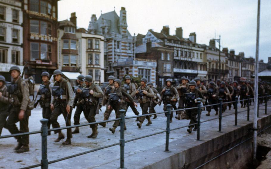 These American troops are marching through the streets of Weymouth, England, in June 1944, on their way to the docks where they will be loaded into landing craft for the big assault.