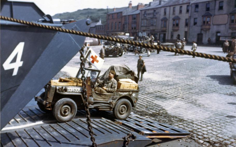 Jeeps being driven into the open doors of a tank landing craft in Portland, England, in preparation for D-Day in June 1944.