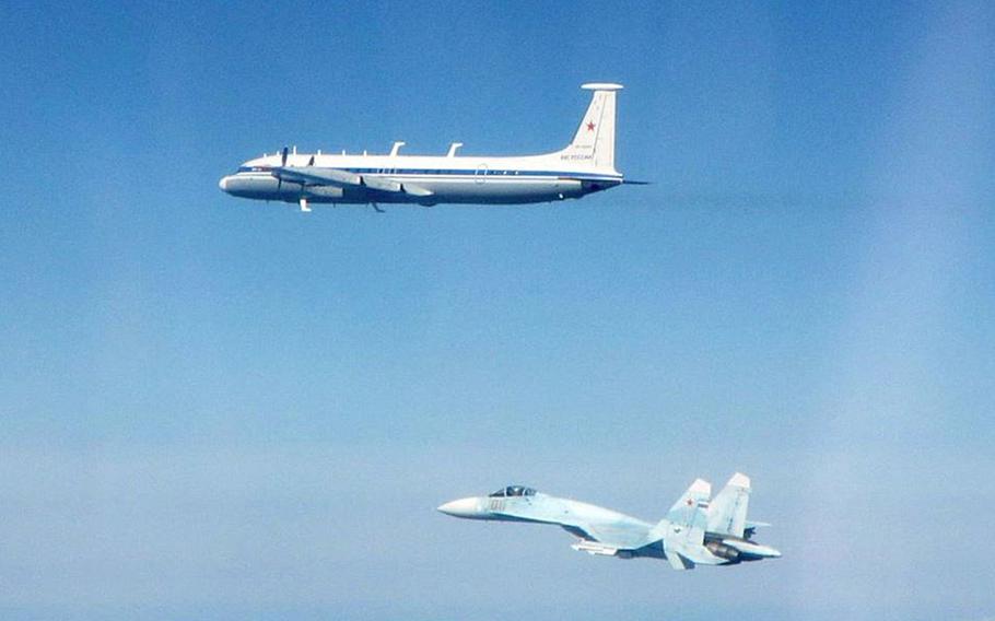 A Russian SU-27 Flanker fighter and an IL-22 aircraft fly along the Baltic coast, Thursday, May 16, 2019.