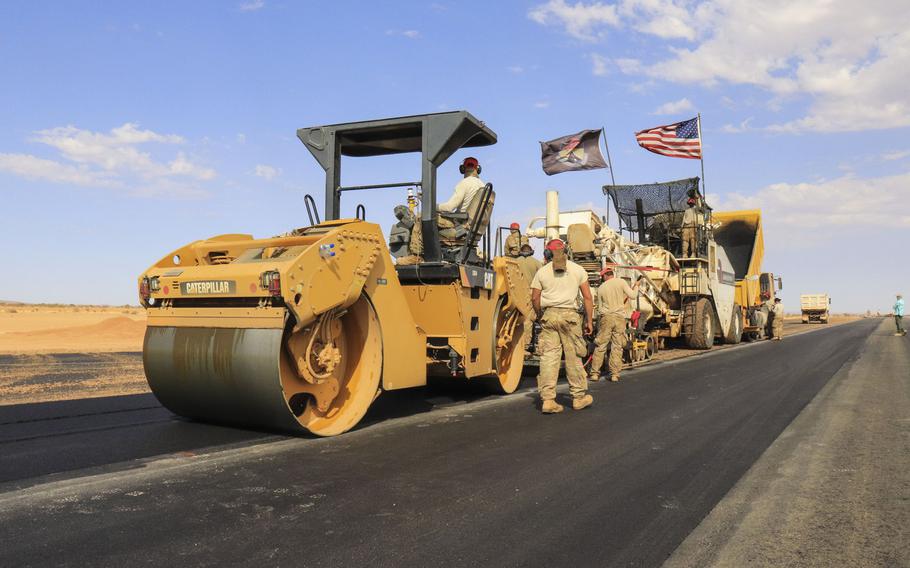 Airmen assigned to the 31st Expeditionary Squadron use a steamroller to level asphalt while paving a flight line on Nigerien Air Base 201, Niger, in December 2018.  The U.S. military?s new base is scheduled to open this summer.
