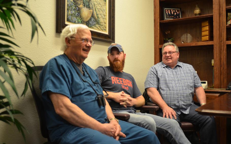 Dr. David Wilhite reconnects with Jason McClure and Warren Frysinger, two veterans he provided with free dental work through the nonprofit Rebuilding America???s Warriors, at his office in Plano, Texas on March 6. Rose L. Thayer/Stars and Stripes