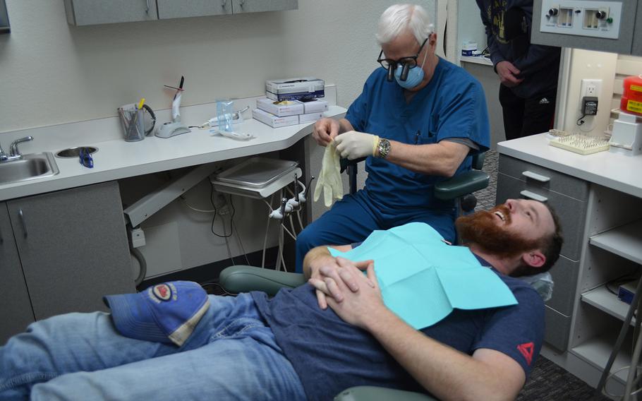 Dr. David Wilhite performs a dental checkup on Jason McClure, a Marine Corps veteran, at his office in Plano, Texas on March 6. McClure???s dental health deteriorated due to his military service and is one of more than 50 veterans to receive free dental work from Wilhite through the nonprofit Rebuilding America???s Warriors. Rose L. Thayer/Stars and Stripes