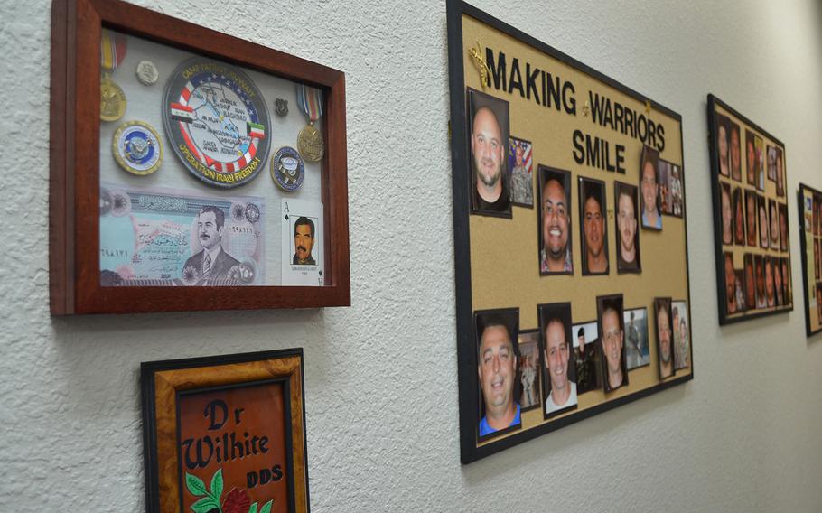 Photos of veterans hang on the wall of Dr. David Wilhite???s dentist office in Plano, Texas. Wilhite has provided free dental work to more than 50 veterans through the nonprofit Rebuilding America???s Warriors. Rose L. Thayer/Stars and Stripes