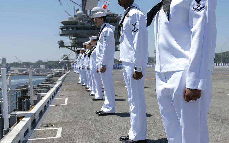 Sailors man the rails on the flight deck of the USS Ronald Reagan as the aircraft carrier departs Yokosuka Naval Base, Japan, Wednesday, May 22, 2019.