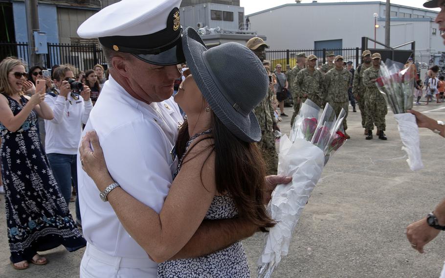 USS Blue Ridge Command Master Chief James Grant kisses his wife after a four-month patrol aboard the U.S. 7th Fleet flagship at Yokosuka Naval Base, Japan, May 29, 2019.