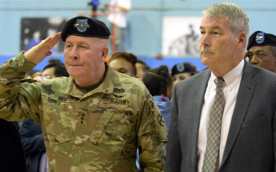 Eighth Army commander Lt. Gen. Michael Bills and Department of Defense Education Activity Director Tom Brady stand at attention for the national anthem during a closing ceremony for the Seoul American school complex, Monday, June 3, 2019.