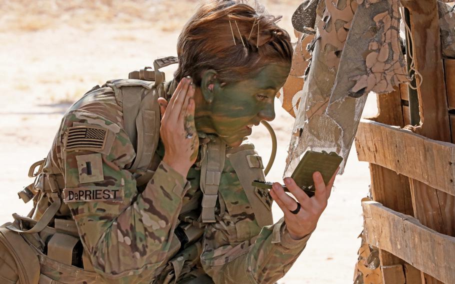 1st Lt. Shelby DePriest with1st Battalion, 8th Infantry Regiment, 3rd Armored Brigade Combat Team, 4th Infantry Division, applies camouflage face paint during patrol lane testing for the Expert Infantryman Badge at Camp Buehring, Kuwait on Friday, May 31, 2019. Upon completion of testing, DePriest became the first female EIB awardee in the 4th Infantry Division.