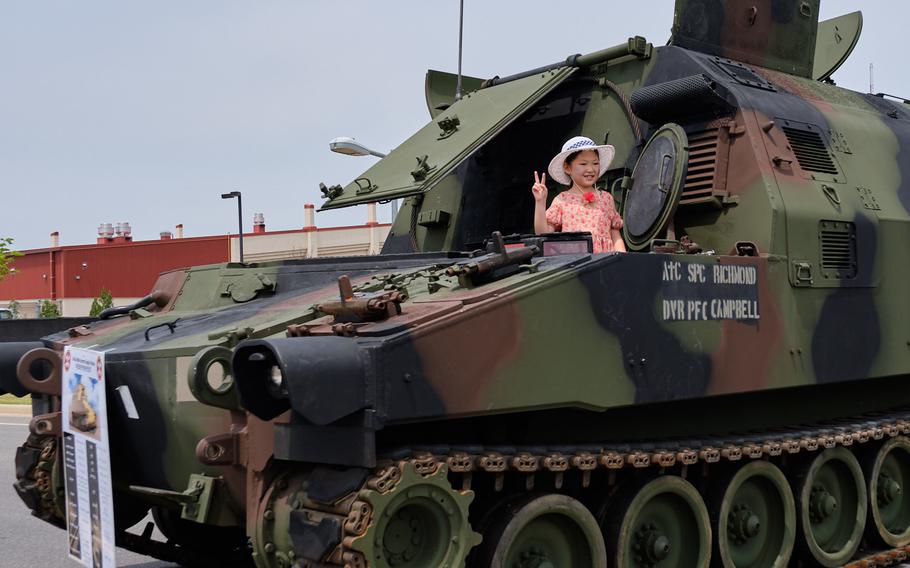 A child poses while standing in a Field Artillery Ammo Supply Vehicle during the Eighth Army's 75th anniversary celebration at Camp Humphreys, South Korea, Saturday, June 8, 2019.