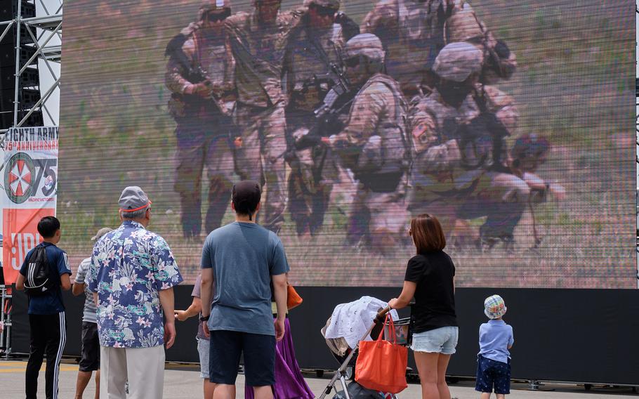 People watch the live feed of a casualty evacuation demonstration during the Eighth Army's 75th anniversary celebration at Camp Humphreys, South Korea, Saturday, June 8, 2019.