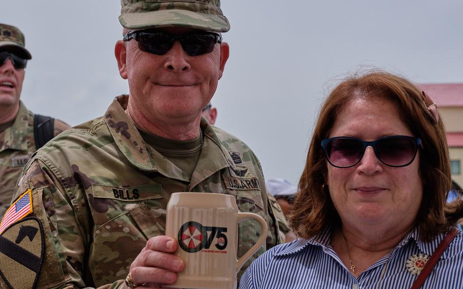 Eighth Army commander Lt. Gen. Michael Bills and wife, Megan, purchase a souvenir mug during the Eighth Army's 75th anniversary celebration at Camp Humphreys, South Korea, Satuday, June 8, 2019.