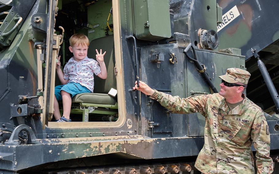 A child poses in the front seat of an M270A1 Multiple Launch Rocket System during the Eighth Army's 75th anniversary celebration at Camp Humphreys, South Korea, Saturday, June 8, 2019.
