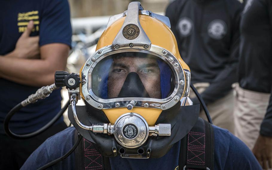 A U.S. sailor assigned to Mobile Diving and Salvage Unit 1 prepares for a dive with the Royal Thai Navy while aboard the Military Sealift Command salvage ship USNS Salvor during Cooperation Afloat Readiness and Training at Sattahip Naval Base, Thailand, June 4, 2019.
