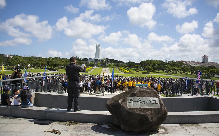 U.S. and Japanese servicemembers are welcomed during a cleanup event at Okinawa Peace Memorial Park in Itoman, Okinawa, Saturday, June 15, 2019.