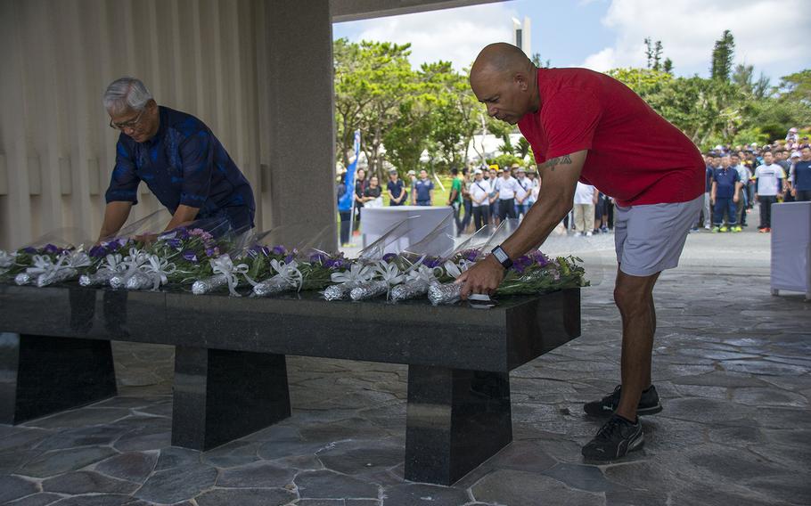 Reiji Maruno, chairman of the Japan Air Self-Defense Force’s Okinawa retirees association, left, and U.S. Army Col. Theodore White, commander of the 10th Support Group at Torii Station, lay flowers during a cleanup event at Okinawa Peace Memorial Park in Itoman, Okinawa, Saturday, June 15, 2019.