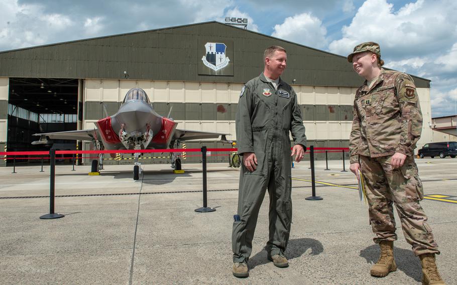 Lt. Col. Richard Orzechowski, 421st Fighter Squadron commander from Hill Air Force Base, Utah, talks with Spangdahlem base spokesman Capt. Erin Recanzone, as an F-35 Lightning II, takes off from Spangdahlem Air Base, Germany, June 18, 2019.