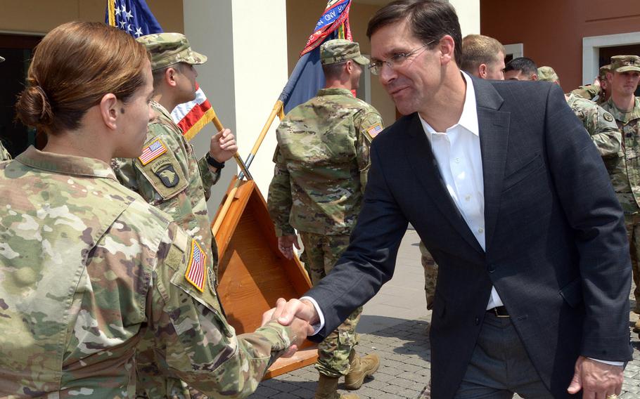 Army Secretary Mark Esper congratulates a soldier assigned to the 173rd Airborne Brigade Combat Team, at the brigade’s headquarters at Caserma Del Din in Vicenza, Italy, June 4, 2019. Esper has been named acting defense secretary by President Donald Trump, and will be heading to Brussels next week for a NATO defense ministers meeting.