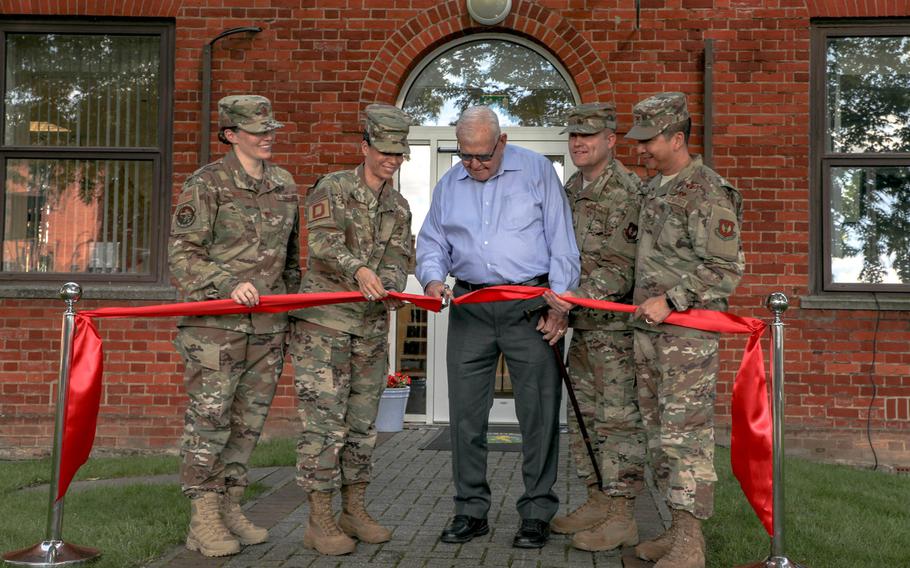 Dewey R. Christopher, center, cuts the ribbon outside the Professional Development Center at RAF Mildenhall, which was renamed after him on June 21, 2019. Looking on from left to right are Maj. Jamie Gegg, Chief Master Sgt. Kristina L. Rogers, Master Sgt. Curtis Brown, and Col. S. Troy Pananon.