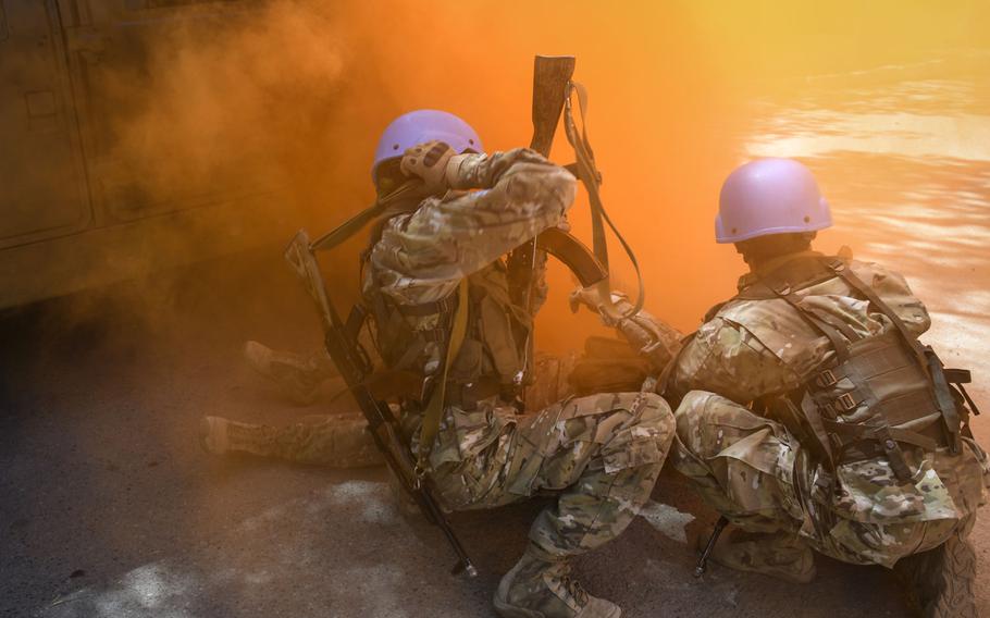 Soldiers from Tajikistan assist a fellow troop with a simulated injury as part of a training exercise between American, British, Tajik and Kazakh troops June 25, 2019. The Steppe Eagle exercise at the Chilikemer Training Area outside Almaty brought together troops for training on peacekeeping and stability operations.