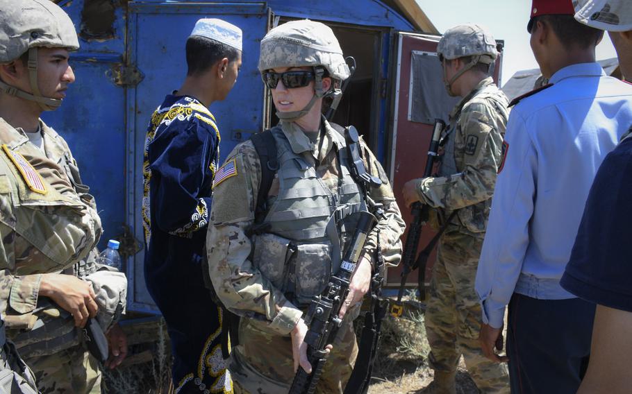 Army Staff Sgt. Jenna Ross, center, leads troops as they search for a weapons cache in a mock village in Chilikemer training area in Kazakhstan during Exercise Steppe Eagle on June 23, 2019. Ross, the first female infantry soldier in the Arizona Army National Guard, is now a squad leader.