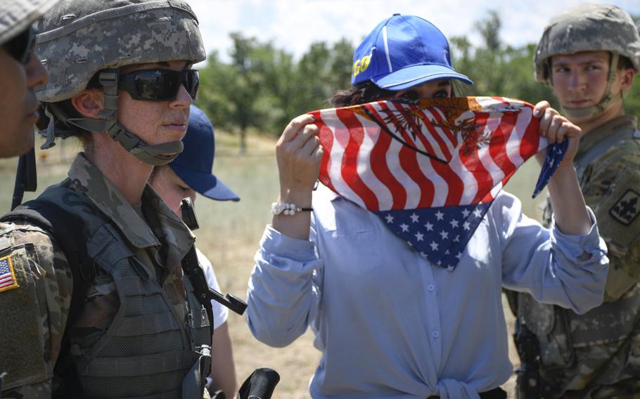 Army Staff Sgt. Jenna Ross, left, talks to female actors posing as civilians in a mock village in Chilikemer training area in Kazakhstan during Exercise Steppe Eagle on June 23, 2019.