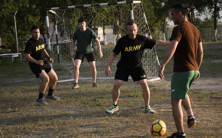 U.S. Army Staff Sgt. Pavel Manchik, second from right, plays soccer with soldiers from Tajikistan during Exercise Steppe Eagle between American, British, Tajik and Kazakh in June, 2019. A native Russian speaker, Manchik served as an unofficial translator during the exercise.