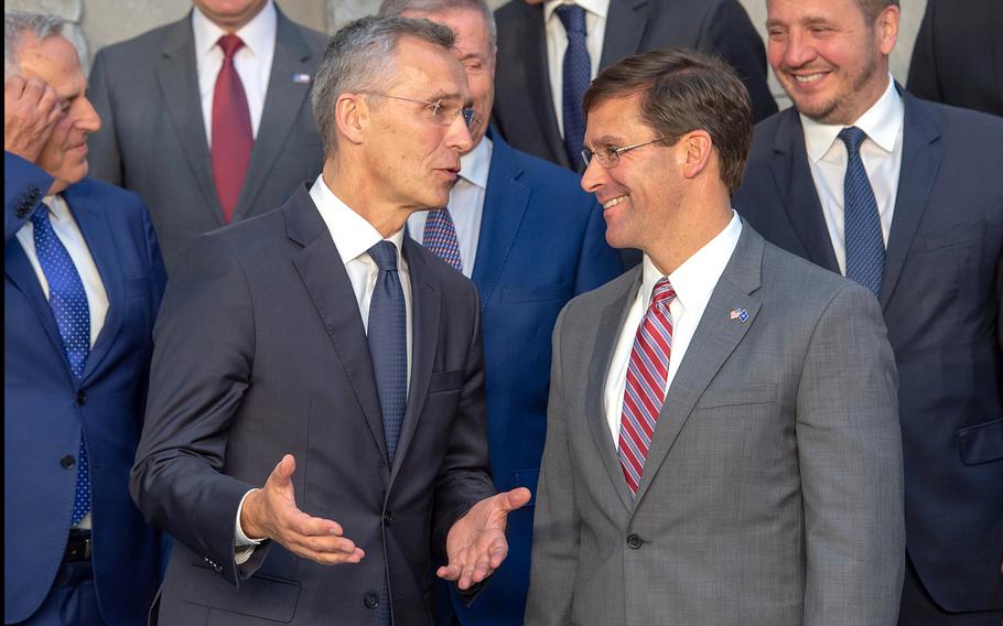NATO Secretary-General Jens Stoltenberg and Acting Defense Secretary Mark Esper talk as dignitaries set up for a group photo on the second day of NATO defense ministers meetings at the alliance's headquarters in Brussels, Belgium, Thursday, June 27, 2019.