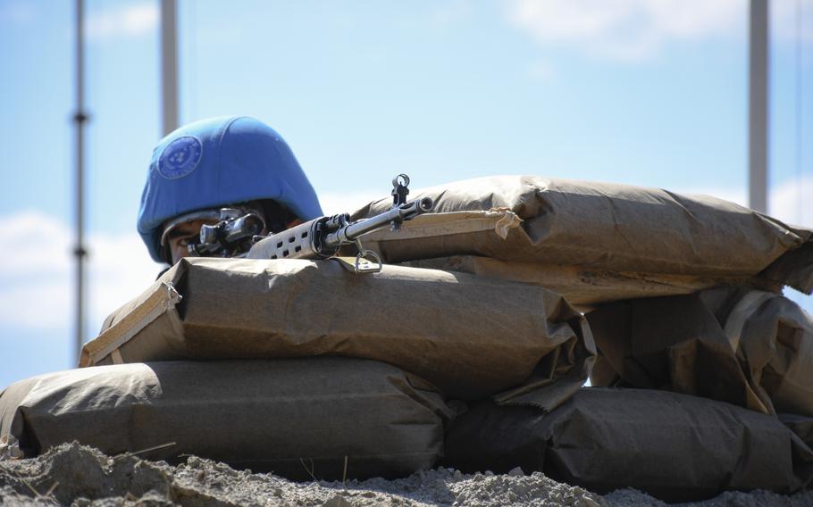 A soldier with the Kazakh Ground Forces' peacekeeping battalion responds to a simulated attack on his base during the U.S.-led Steppe Eagle exercise in the Chilikemer Training Area near Almaty, Kazakhstan on June 23, 2019.
