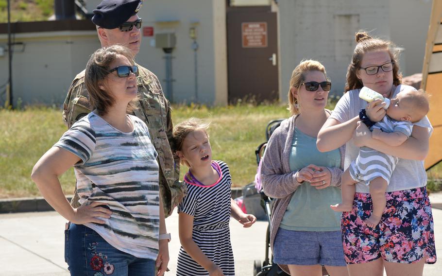 Family, friends and fellow airmen watch members of Ramstein's 435th Contingency Response Group parachute onto the base after jumping from a C-130J Hercules of the 37th Airlift Squadron on Tuesday, July 2, 2019.