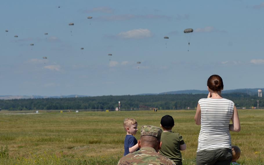 Family, friends and fellow airmen watch members of Ramstein's 435th Contingency Response Group parachute onto the base after jumping from a C-130J Hercules of the 37th Airlift Squadron on Tuesday, July 2, 2019. 