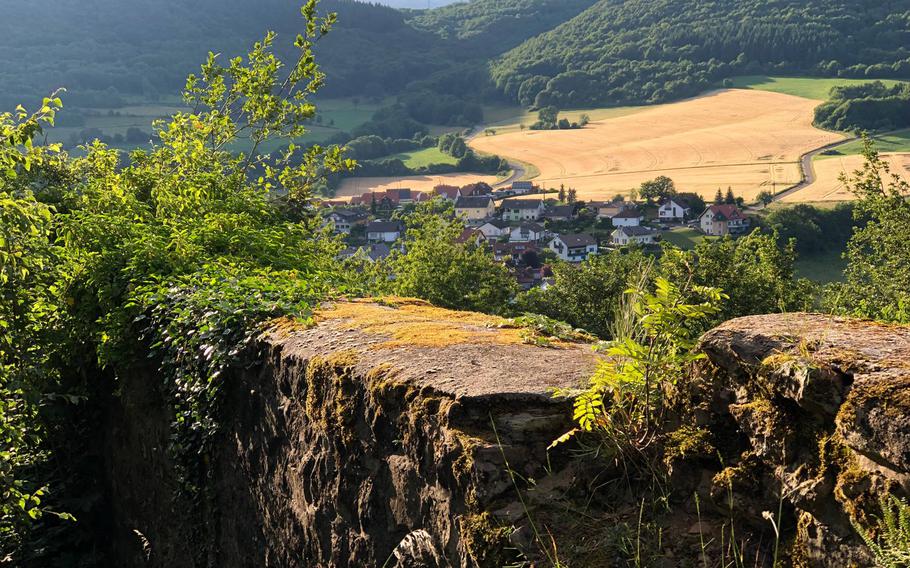 The village of Thallichtenberg can be seen over the 800-year-old walls at Lichtenberg Castle, Germany.