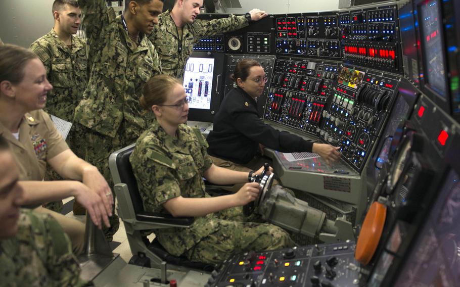 Sailors assigned to the guided missile submarine USS Ohio practice driving a simulated submarine in the ship's control trainer at Trident Training Facility Bangor in June 2018. 