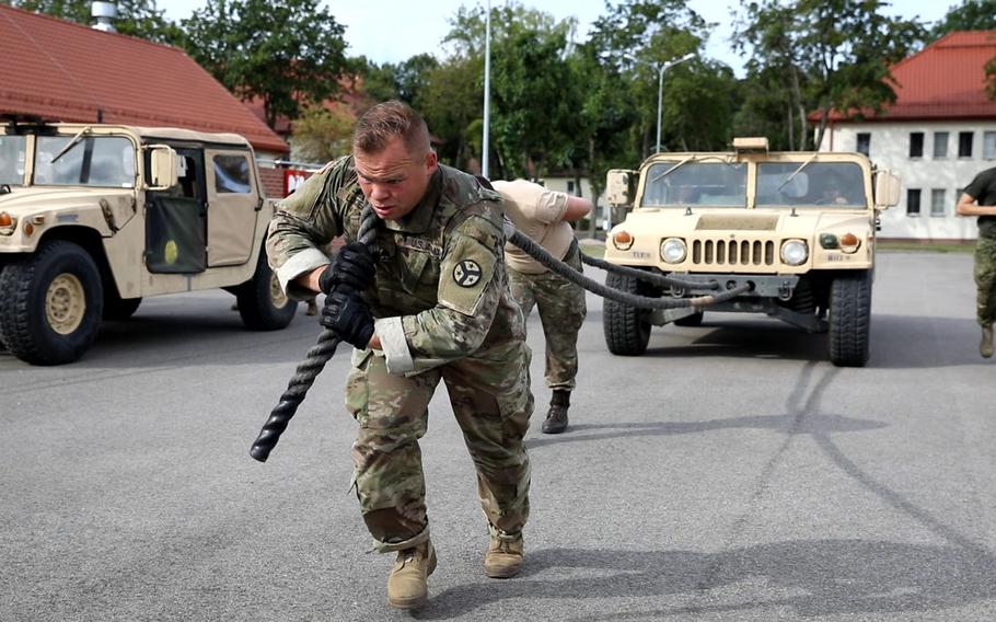 A U.S. soldier helps his team pull a Humvee during the Interoperability Games in Bemowo Piskie, Poland, Saturday, August 3, 2019.