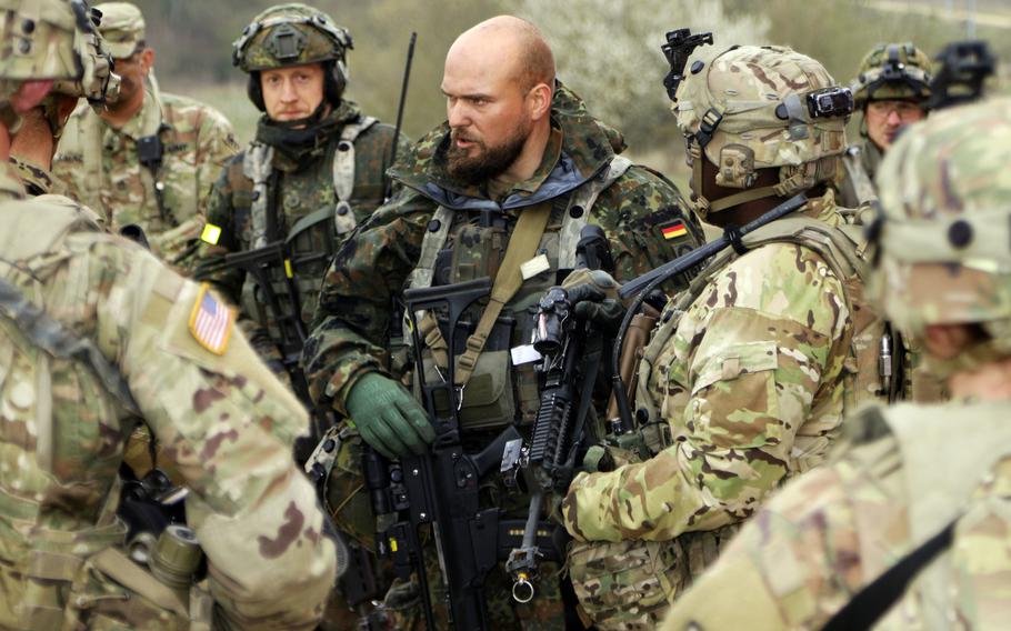 Soldiers of the 92nd Military Police Company strategize with their German counterparts at the Hohenfels Training Area in southeastern Germany. Chancellor Angela Merkel has said the country must strive to improve its military.