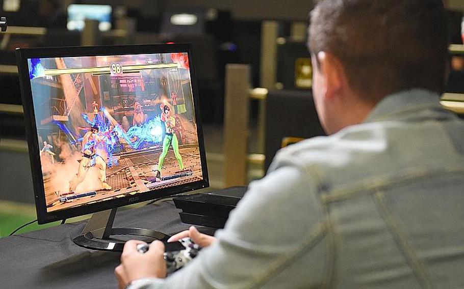 Gamer Ziggy113, a U.S. Army soldier, launches a "Hadouken" fireball as Ryu, in the Street Fighter V tournament at Vilseck, Germany, Saturday, Aug. 17, 2019. 