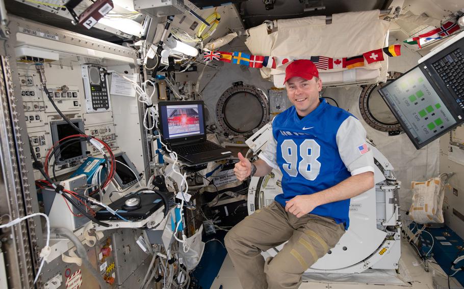 Astronaut Nick Hague watches a video his classmates from  the Air Force Academy's class of 1998 sent him while aboard the International Space Station.