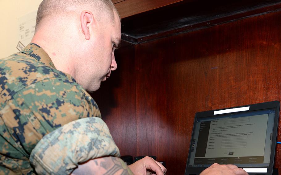 Gunnery Sgt. Tyler Nichols registers to vote during the  Marine Corps Logistics Base Albany, Ga.'s first voting convention in 2017. Marines can encourage others to vote, but they remain restricted both in person and online when it comes to advocating for political candidates.