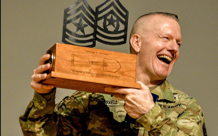 Command Sgt. Maj. John Wayne Troxell, senior enlisted adviser to the chairman of the Joint Chiefs of Staff, shows the memento presented to him during his last visit to the NCO Leadership Center of Excellence in El Paso, Texas, Nov. 21, 2019. Troxell retires Dec. 13, after nearly 38 years in the Army.