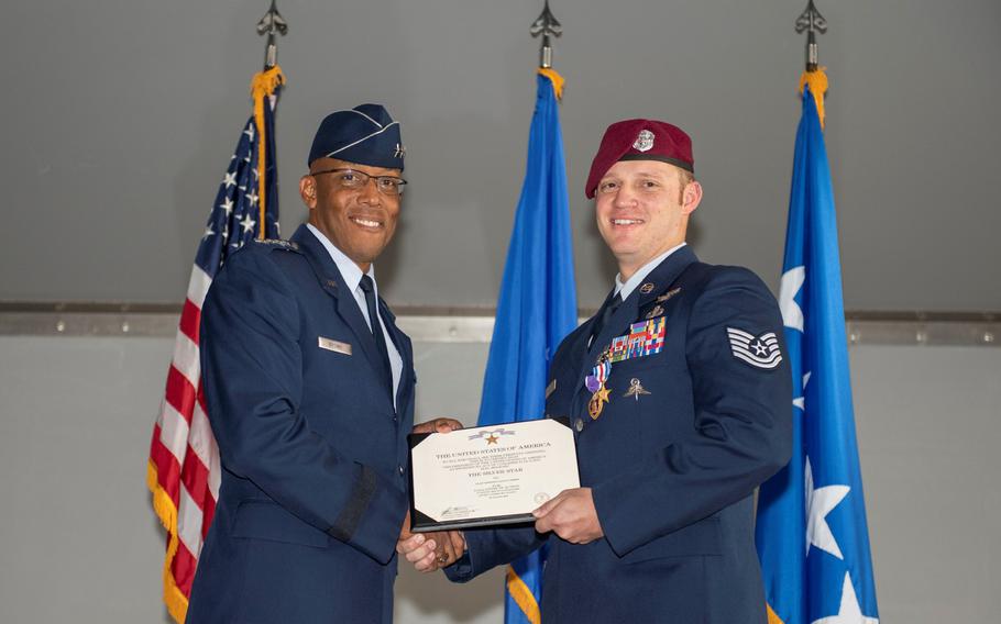 Gen. Charles Q. Brown Jr., Pacific Air Forces commander, presents the Silver Star Medal to Tech. Sgt. Gavin Fisher, 350th Special Warfare Training Squadron pararescueman, in a ceremony at Nellis Air Force Base, Nev., Dec. 13, 2019.