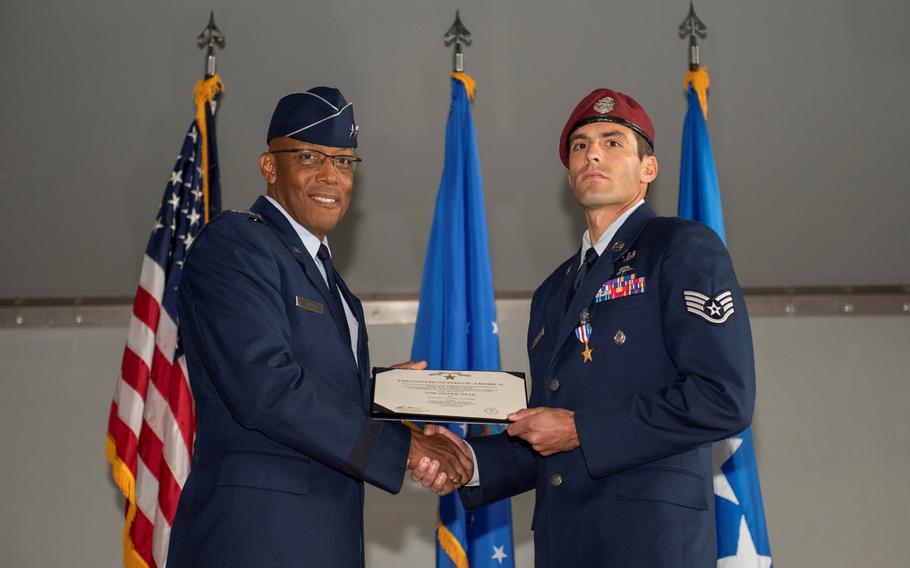 Gen. Charles Q. Brown Jr., Pacific Air Forces commander, presents the Silver Star Medal to Staff Sgt. Daniel Swensen, 58th Rescue Squadron pararescueman, in a ceremony at Nellis Air Force Base, Nev., Dec. 13, 2019.