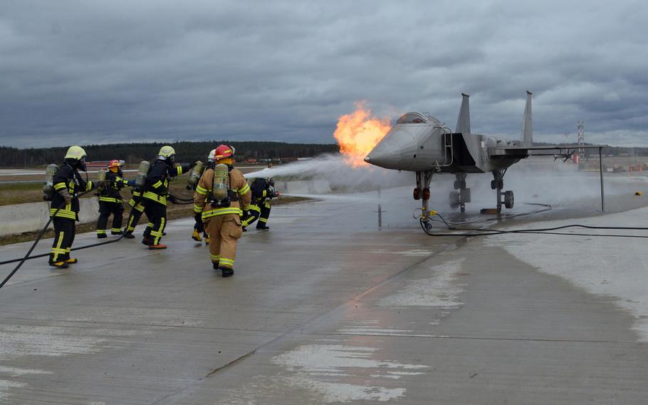 A team of Lithuanian firefighters put out the flames coming from a mock fighter jet engine on Wednesday, March 11, 2020. Firefighters from four NATO nations practiced putting out fires at the USAFE Fire Academy on Ramstein Air Base, Germany.