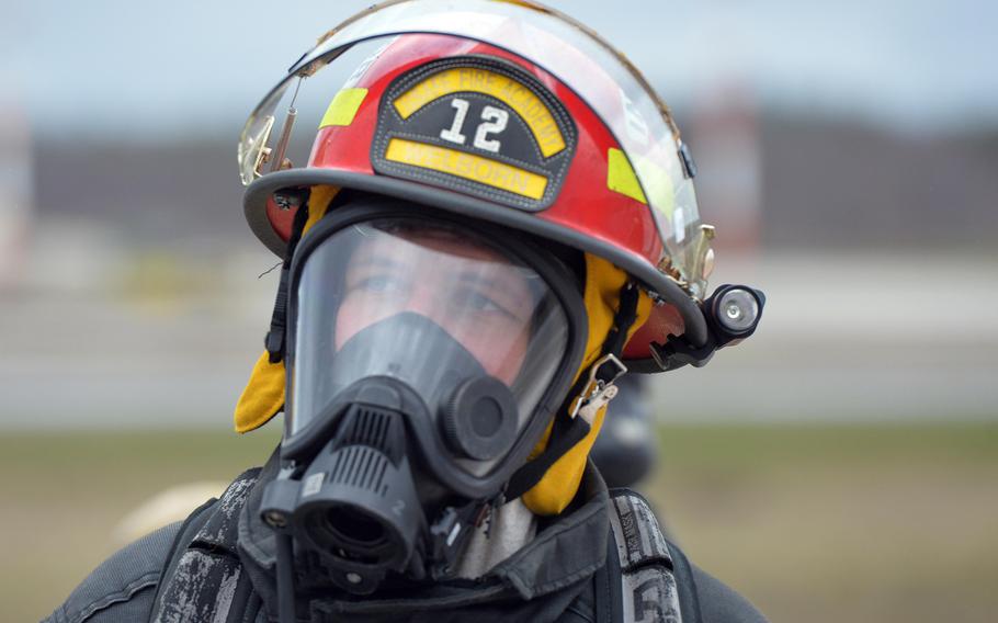 Staff Sgt. Robert Welborn of the 435th Construction and Training Squadron at Ramstein Air Base, Germany, watches a team of firefighters prepare to put out a fire, March 11, 2020. Firefighters from four NATO nations practiced putting out fires at the USAFE Fire Academy on Ramstein Air Base, Germany.