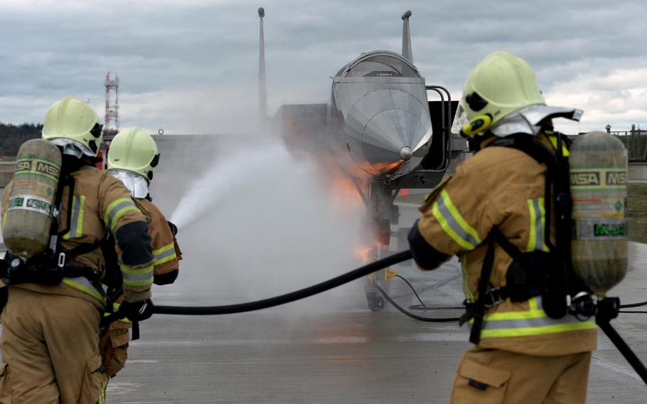 The Latvian firefighting team puts out a fire in the engine of a jet fighter mockup at Ramstein Air Base, Germany, March 11, 2020. Firefighters from four NATO nations practiced putting out fires during training led by the 435th Construction and Training Squadron.