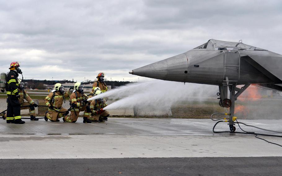 The Latvian firefighting team puts out an engine fire on a mockup of a fighter jet, March 11, 2020. Firefighters from four NATO nations practiced putting out fires at the USAFE Fire Academy on Ramstein Air Base, Germany.