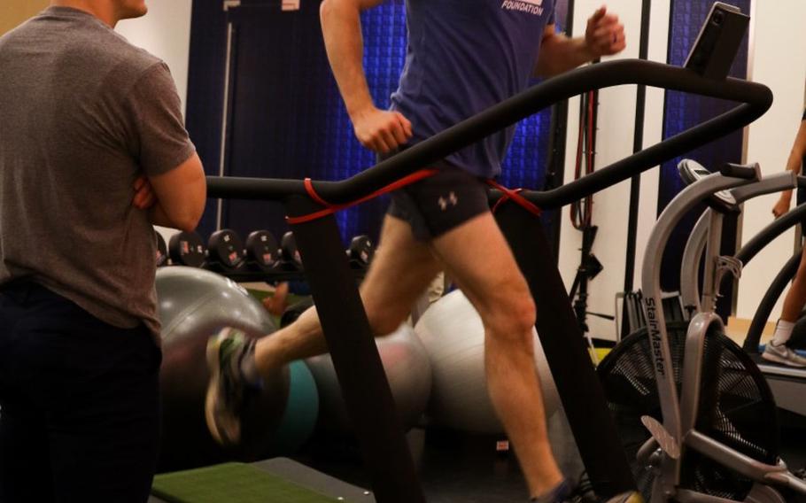 Former Green Beret Kevin Flike runs on a treadmill with his fitness coach, Jordan Lowry, while training for the Boston Marathon at the TB12 Sport Therapy Center, Foxborough, Mass., in April 2018. Flike, 35, promised himself he would run a marathon after getting shot by a Taliban sniper in Afghanistan in 2011.