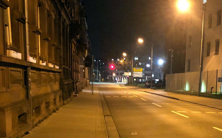 Logenstrasse near the soccer stadium and train station in Kaiserslautern, Germany, stands empty about 9:45 p.m. Friday, March 20, 2020. The Kaiserslautern-based 21st Theater Sustainment Command has placed a 10 p.m. to 5 a.m. curfew on personnel and family members.