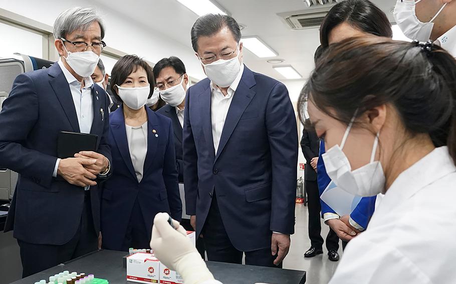 South Korean President Moon Jae-in visits a Seoul-based company developing diagnostic solutions for fighting the coronavirus, Wednesday, March 25, 2020.