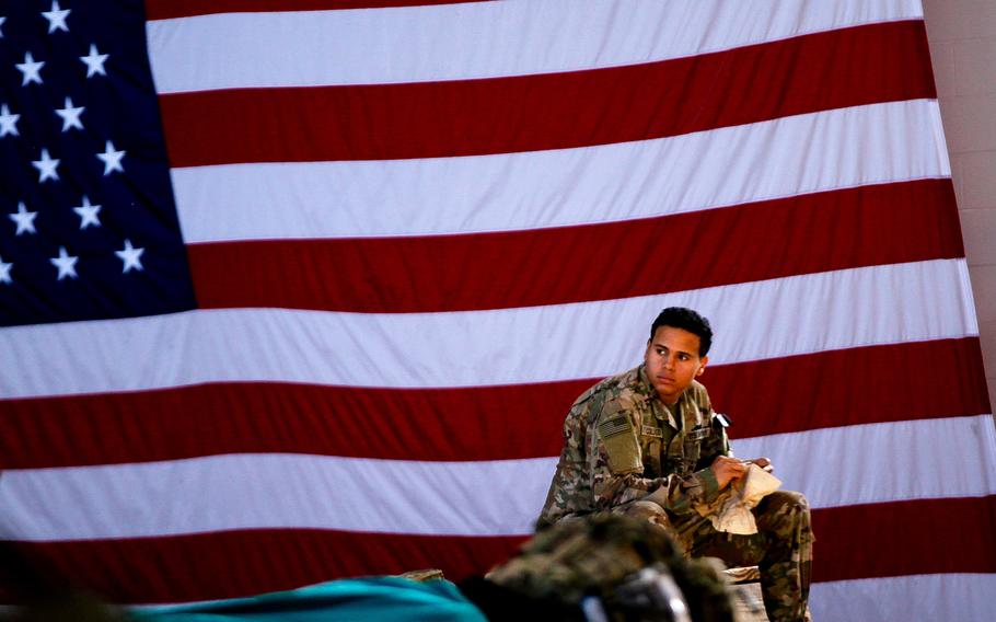 A soldier assigned to 1st Brigade Combat Team, 82nd Airborne Division waits to board an aircraft bound for the Middle East, from Fort Bragg, N.C. on January 5, 2020.  Some 2,500 soldiers rapidly deployed days after Christmas and are now separated from their families indefinitely as the military works to fight the spread of the coronavirus.