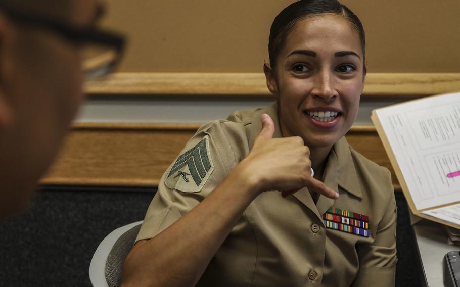 U.S. Marine Corps Sgt. Alexandria Aglio, the career planner for Headquarters Battalion, Marine Corps Base Hawaii, speaks to a Marine during the annual Manpower Management Enlisted Assignments Roadshow, MCBH, Aug. 20, 2019. The Marine Corps may change the way it holds selection boards to allow them to respect social distancing rules, which are key to fighting the coronavirus.